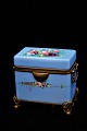 Antique sugar 
box in opaline 
glass painted 
in blue with 
fine floral 
motifs and 
bronze 
mounting. ...