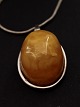 Amber pendant 
2.5 x 3.4 cm. 
with sterling 
silver mounting 
and chain 42 
cm. Item No. 
519072