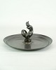 Dish, designed 
by Just 
Andersen with a 
motif of a 
mermaid figure 
in disco metal 
from the 1930s. 
...