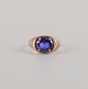 Gold ring decorated with purple semi-precious stones, Danish goldsmith.
Approx 1970.
Marked "RNS".