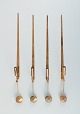Skultuna, Sweden, four brass candlesticks for wall hanging.Designer: Pierre Forsell. Marked ...