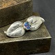 Length 3.5 cm.Nice brooch from the 1950s in silver.It has leaves around the blue glitter ...
