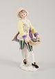 Presumably 
German 
porcelain 
figure, man 
with flower 
basket, 19th 
century.
Indistinctly 
signed. ...