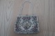 Vintage /retro:
Beautiful old handbag
Mit embroidery (but as far as we judge, not made 
by hand)
Beautiful closing item 
About 1960