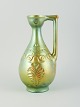 Zsolnay, 
Hungary. Large 
ceramic jug 
with eosin 
glaze modeled 
with foliage.
Mid 20th ...