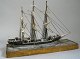 Model ship in 
wood, 
three-masted, 
Denmark, 19th 
century. On 
wooden foot 
with grained 
paintings ...