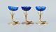 Gunnar Ander 
for Ystad 
Metall. Two 
candlesticks in 
brass and blue 
art glass 
shaped like ...