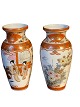 Pair of Japanese Kutani vases decorated in orange and gold panels with motifs of garden scenes ...