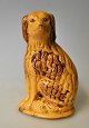 Saving bank in 
the shape of a 
sitting dog, 
Rønne, 
Bornholm, 
Cocker Spaniel. 
19th century. 
Yellow ...