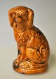 Saving bank in 
the shape of a 
sitting dog, 
Rønne, 
Bornholm, 
Cocker Spaniel. 
19th century. 
Yellow ...