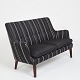 Arne Vodder. Two-seather sofa upholstered in black and white striped savak with tapered legs of ...
