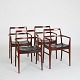 Four rosewood 
armchairs 
designed by 
Arne Vodder. 
Seats 
upholstered in 
original black 
...