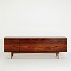 Ib Kofod-Larsen. FA66 low sideboard of rosewood.Front with four drawers and four doors.The ...