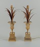 Charles & Fils, France.
A pair of table lamps in patinated metal, designed with palm leaves in a vase.