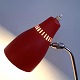Metal table 
lamp with red 
lacquered 
shade. 
Adjustable 
screen with 
switch 
button.H. 32 
cm.