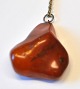 Polished amber 
necklace with 
silver chain, 
Denmark. 4 x 
3.8 cm. Chain 
length: 44 cm.