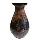 Danico; A big 
pottery vase.
Decorated with 
a brown glaze, 
decorated with 
blue, green and 
coral. ...