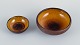 Osa, Denmark.
Two small 
retro unique 
ceramic bowls 
with glaze in 
yellow-brown 
...