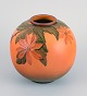 Ipsens, 
Denmark, round 
ceramic vase. 
Glaze in orange 
and green 
tones.
1920/30s.
Floral ...