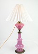 This table lamp is a beautiful example of design from the 1880s. The lamp has a frame of pink ...