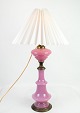 This table lamp 
is a beautiful 
example of 
design from the 
1880s. The lamp 
has a frame of 
pink ...