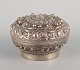 Chinese 
silversmith. 
Lidded jar 
richly 
decorated in 
relief with 
flowers and 
ornaments.
China ...