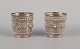 Chinese 
silversmith. 
Two small 
goblets richly 
decorated in 
relief with 
flowers and ...