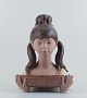 Lladro, Spain. 
Very large two 
piece figurine 
in glazed 
ceramic.
Girl with 
bowl.
1970/80s.
In ...