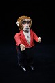 Old Schuco monkey in fine fabric clothes.Height: 12,5cm. (without key)