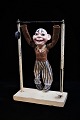 Decorative old clown doll in papier mache hanging on a gymnastic bar in metal and wood. Height: ...