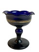 Candy bowl, 
sugar bowl, 
sugar dish. 
Blue glass with 
gold stripe. 
Wavy edge. 
Decline on one 
tip - ...