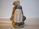 Royal 
Copenhagen 
Figurine, 
Peasant Girl 
with Lunch.
Decoration 
number 815.
Factory ...
