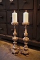 A pair of antique French 19th century wooden candlesticks with remnants of old silver coating ...