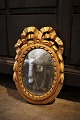 Decorative oval French early 19th century Louis d.XVI gilded wooden mirror with fine decorations ...
