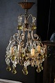 Decorative, old 
French 
chandelier with 
clear glass 
prisms and 
glass balls in 
a delicate 
yellow ...