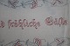 An old table 
cloth with 
embroidery, 
handmade
130cm x 30cm
Text: "Im 
Hause das Beste 
sind ...