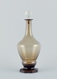 Danish 
glassworks, 
mouth-blown Art 
Deco wine 
decanter in 
smoked glass 
with faceted 
base.
Dating ...