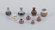 Stouby Keramik, Denmark, a collection of nine miniature ceramic vases with glaze 
in brown and sandy tones.