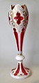 Bohemian Art 
Nouveau vase in 
red glass with 
white border, 
approx. 1900. 
With grindings 
and ...