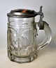 German beer mug 
in glass with 
pewter/porcelain 
lid, 19th 
century. 
Pressed glass 
mug. Pewter lid 
...