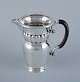 Georg Jensen, 
large Art 
Nouveau pitcher 
in sterling 
silver. Early 
and rare model. 
Hammered ...