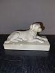 Figure of a lying dog on a base made of terracotta. Made around 1900. Several small chips around ...