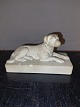 Figure of a 
lying dog on a 
base made of 
terracotta. 
Made around 
1900. Several 
small chips 
around ...