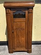 Older cabinet in oak veneer with faceted glass pane. From the beginning of the 1900s, Some small ...