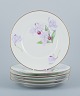 Royal Copenhagen, a set of six Art Nouveau plates hand-painted with lilies and 
gold trim.