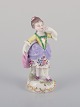 Antique German porcelain figurine. Young woman in elegant attire. Hand-painted 
in polychrome colors.