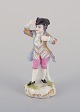 Meissen, 
Germany, 
porcelain 
figurine of a 
young man in 
elegant attire. 
Hand-painted in 
...