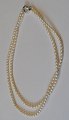 Double row 
pearl chain, 
saltwater 
pearls, 20th 
century With 
silver clasp. 
L.: 38 cm. and 
44 cm.