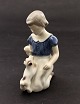 Bing & Grøndahl 
porcelain 
figure 2316 of 
a girl with a  
dog. 1st 
sorting H: 
13cm. subject 
no. 544998