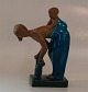 21565 RC Woman 
with child on 
the back 7.25" 
x 5.25" 
Turquoise glaze 
and unglazed 
terracota / ...